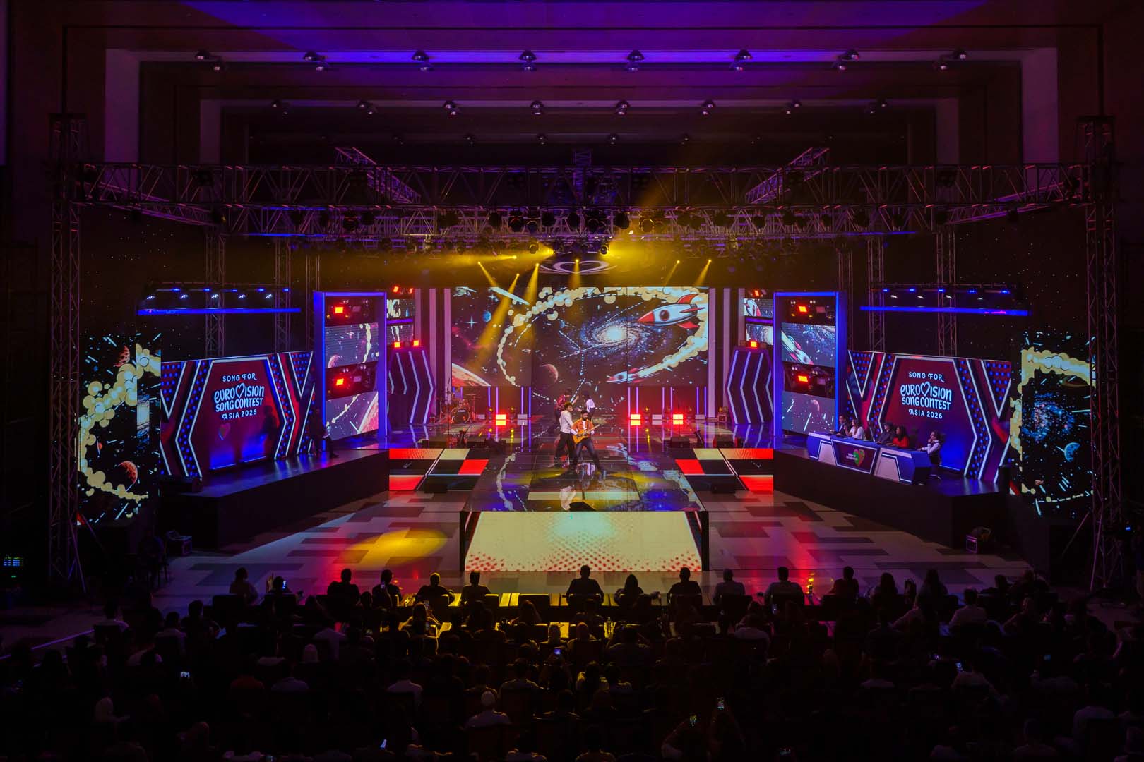 Galaxy and planets LED visuals with warm stage lights